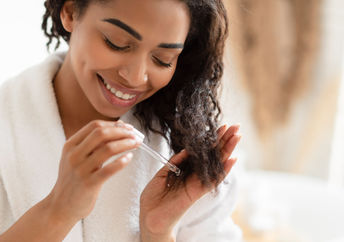 Woman using an organic oil in her hair.