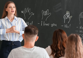 Teacher instructing a class on signing.