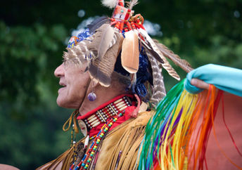 A Native American man from the Pokanoket Wampanoag tribe wearing traditional clothing at a                                   local powwow in Haverhill, Massachusetts, USA.