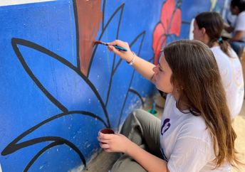 Painting a mural in Panama on Good Deeds Day.