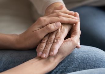 Two people hold hands.