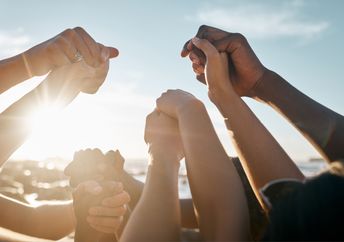 A group of people holding hands.