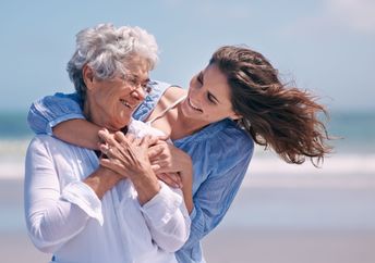 A daughter hugs her mother.