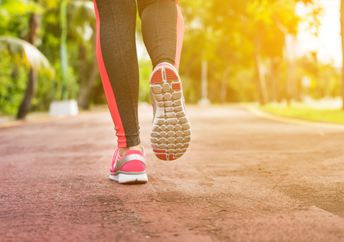 A woman trains and jogs.