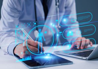 A doctor uses technology.