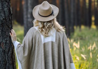Woman contemplating the stillness of the forest.