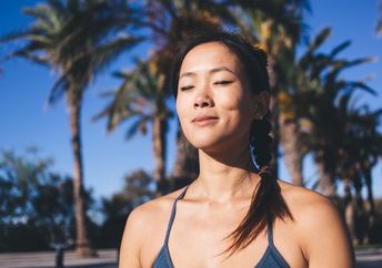 A woman with closed eyes rests.