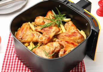 Cooking chicken wings in an air fryer.