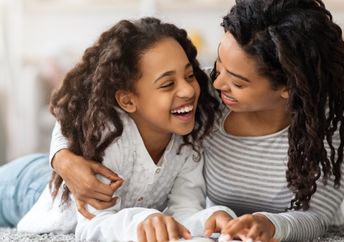 Mother and daughter reading about Black History.