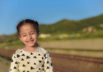 An Arab girl smiles sweetly.