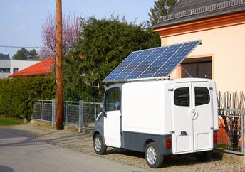A car with a solar panel battery on the roof.