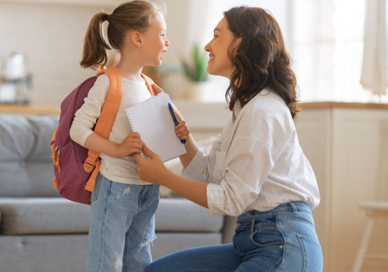 Mother and daughter with backpack and notebook