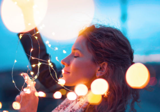Woman holding fairy lights