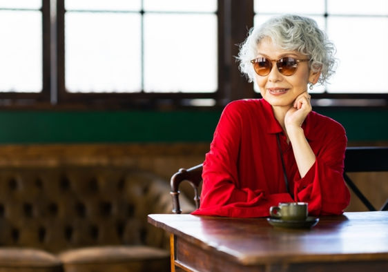 Senior Japanese woman relaxing in a restaurant.