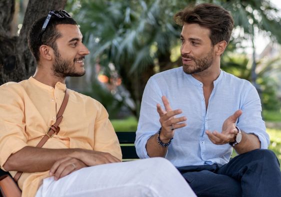 Two male friends having a conversation.