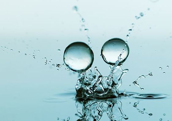 Gel balls falling against a blue background.