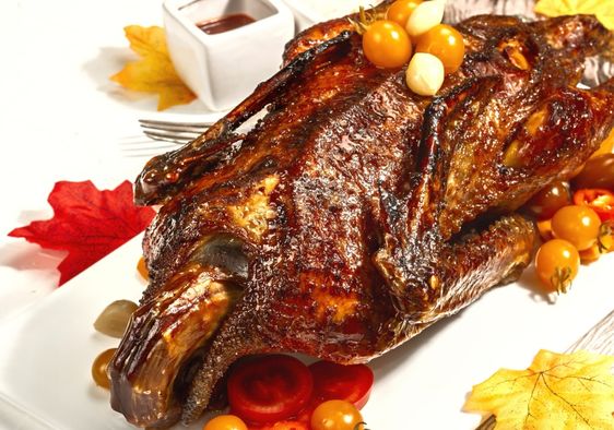 Serve a roasted duck for an authentic Thanksgiving experience.