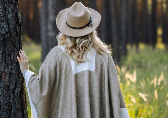 Woman contemplating the stillness of the forest.