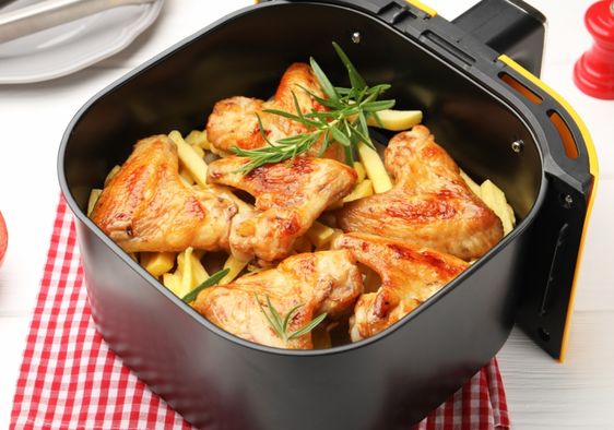 Cooking chicken wings in an air fryer.