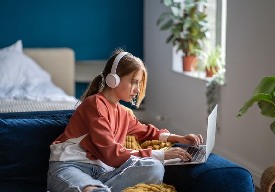 A teen focused on an online lesson.