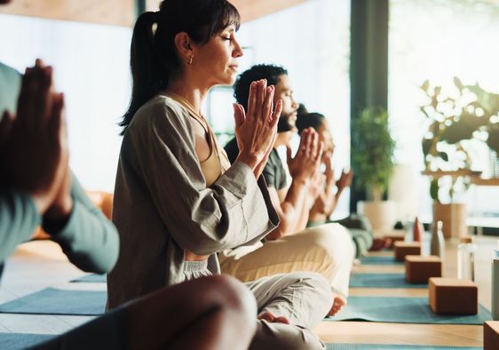 People relaxing in a yoga class.