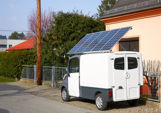 A car with a solar panel battery on the roof.