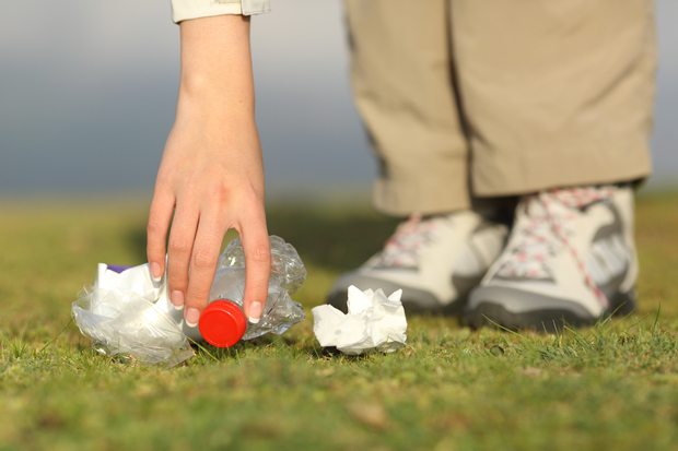 A person picking up litter.