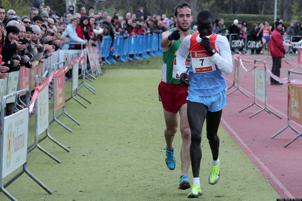 Ivan Fernandez Anaya guides Abel Mutai to the finish line