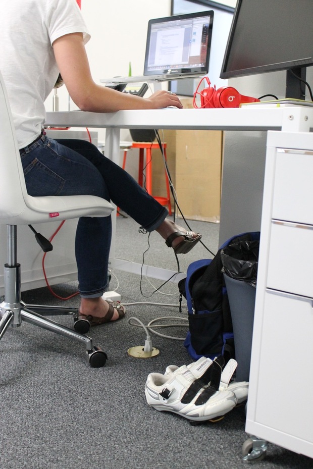Bicycling shoes beneath a PeopleForBikes desk