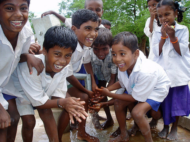 Water.org beneficiaries enjoying a new hand pump