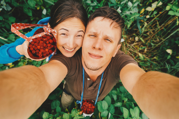 Happy couple with raspberries