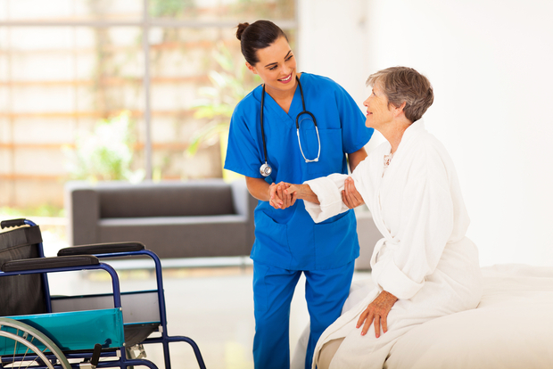 A nurse helps a patient