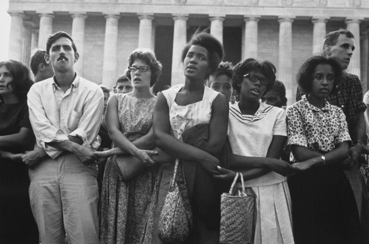 Blacks and whites holding hands during the march on washington