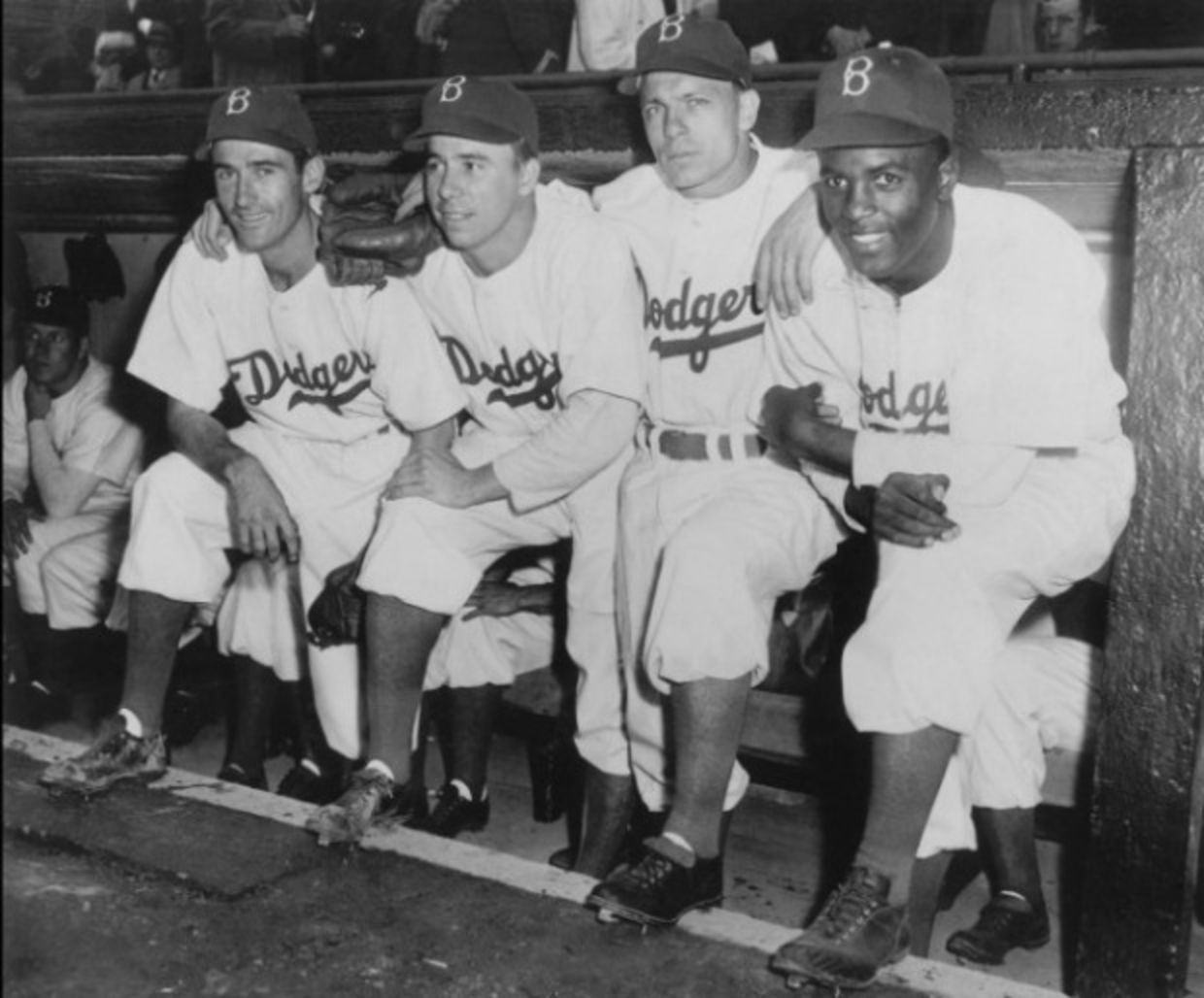 Jackie Robinson and teammates in dugout