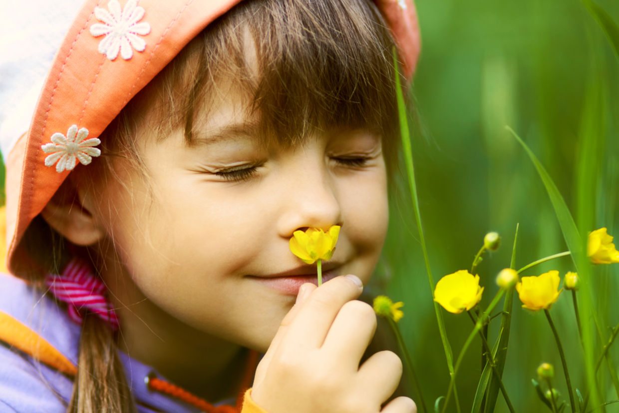 A girl smelling flowers