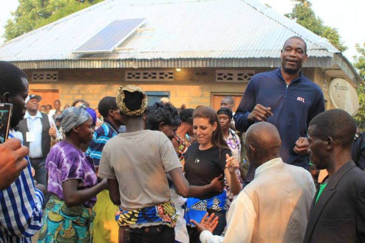 Innovation: Africa's Founder & President, Sivan Ya'ari and Dikembe Mutombo dance with Chief Iba of Bu Village in the Democratic Republic Congo. (Innovation: Africa)