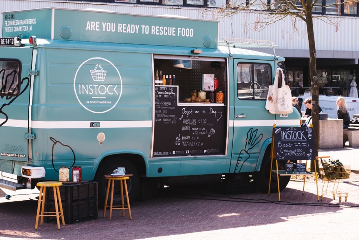 A food truck of the instock restaurant stands by the street