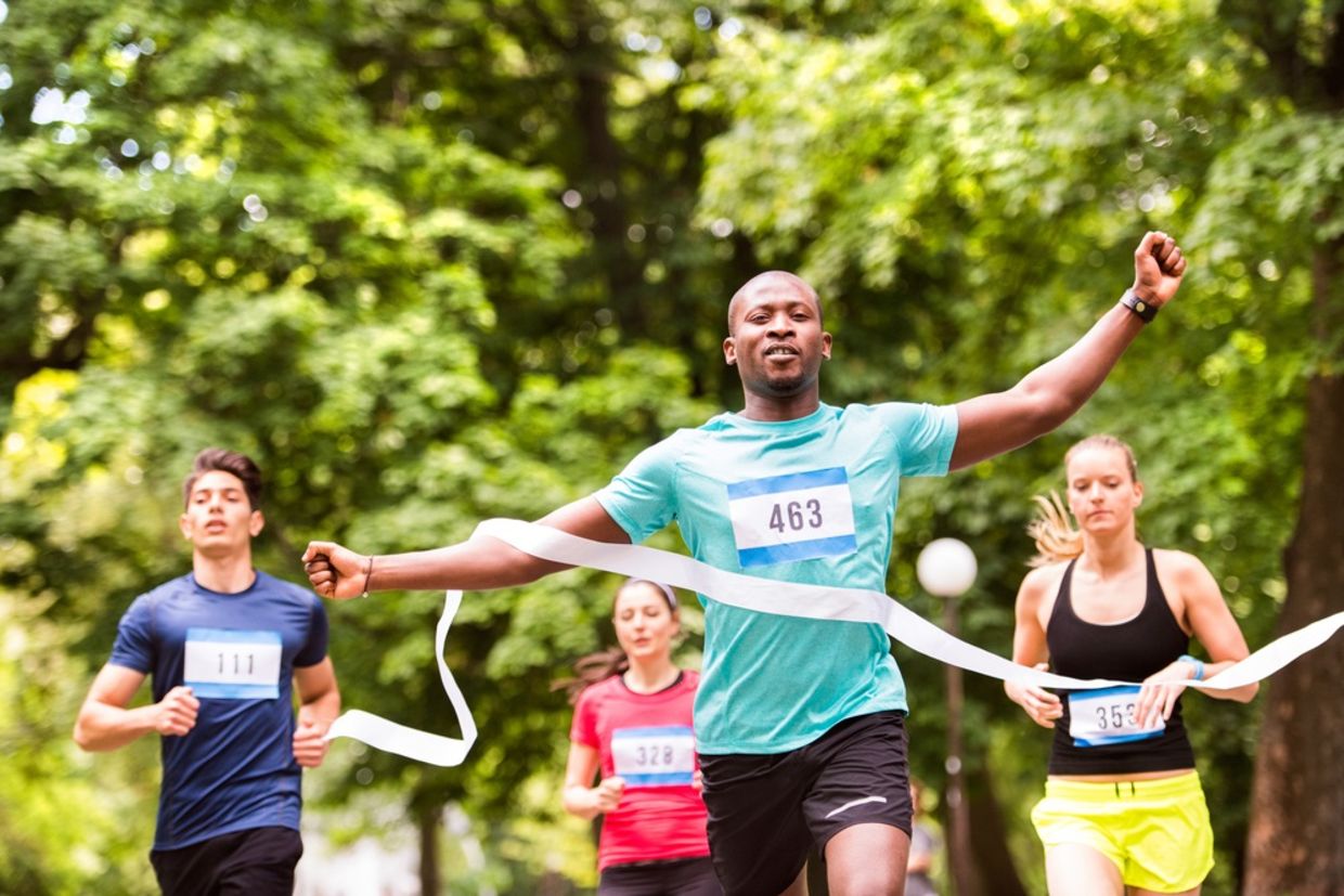 A runner crosses the finish line a ahead of his competitors