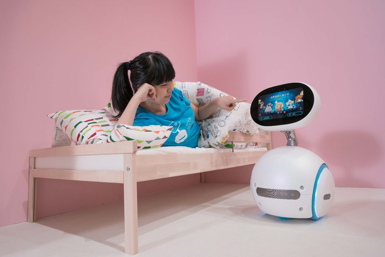 A girl plays with Asus Zenbo home robot