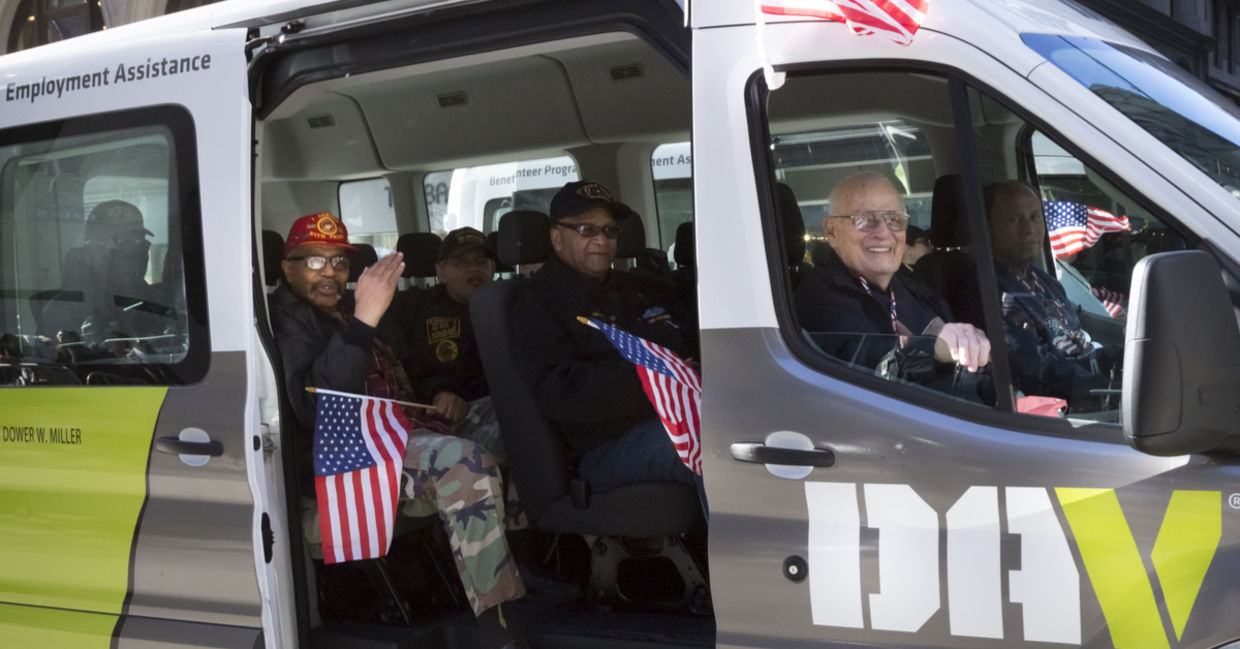 Vets wave the American Flag from the DAV, Disabled American Veterans, van during the 2016 annual America's Parade held on Veterans Day in Manhattan
