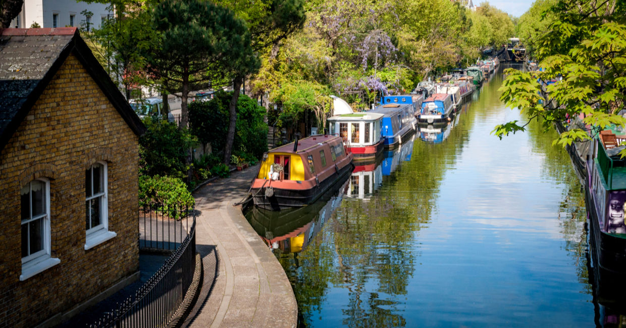 Rows of houseboats and narrow boats on the canal banks at Regent's Canal next to Paddington in Little Venice, London