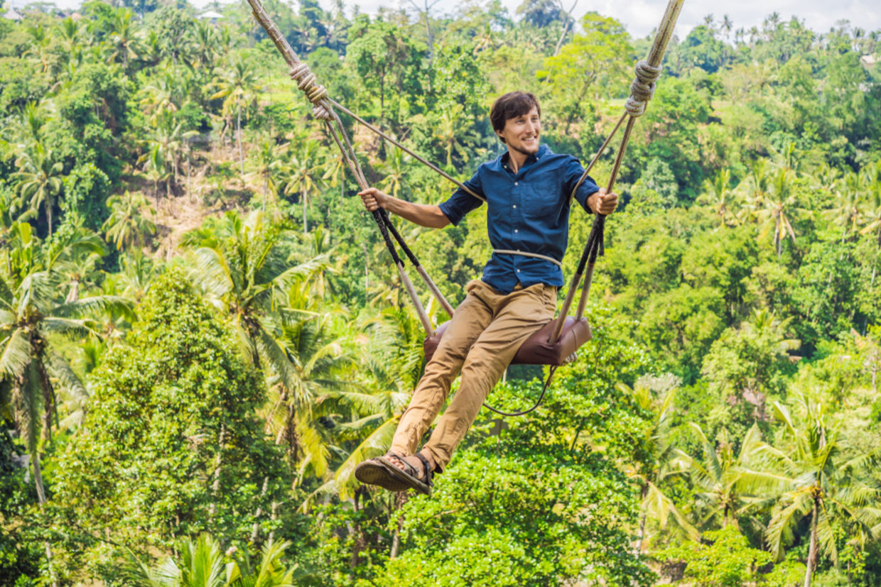 man swinging on swing