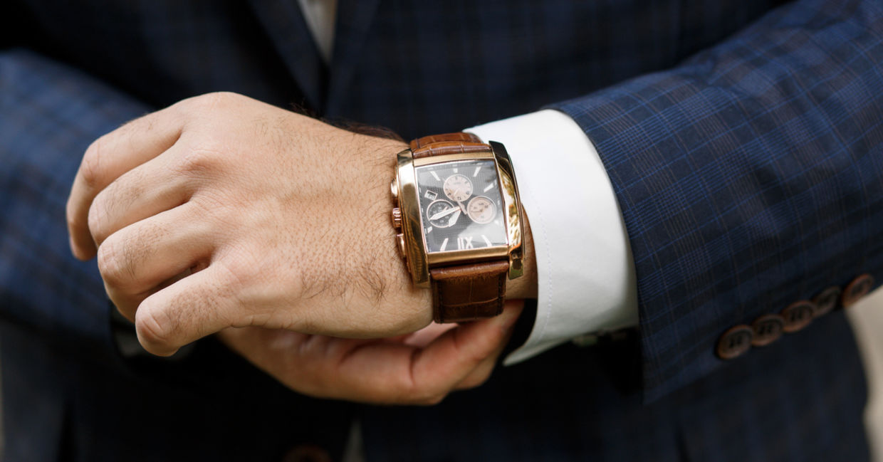 A closeup of designer watch on a businessman's hand
