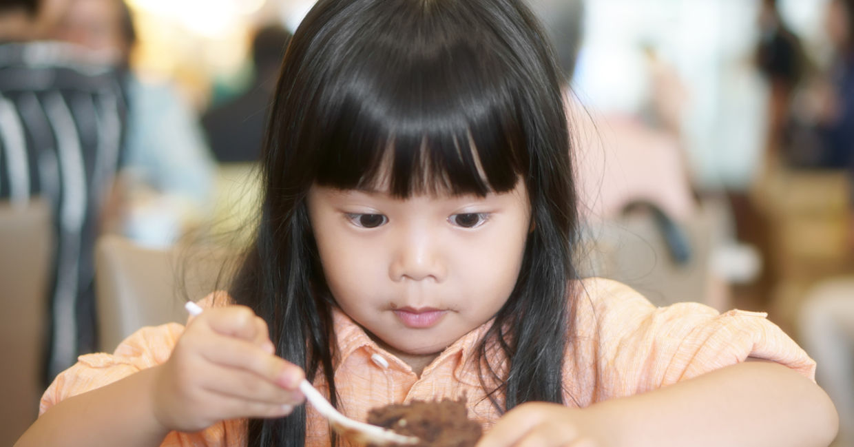 Young girl enjoying cake