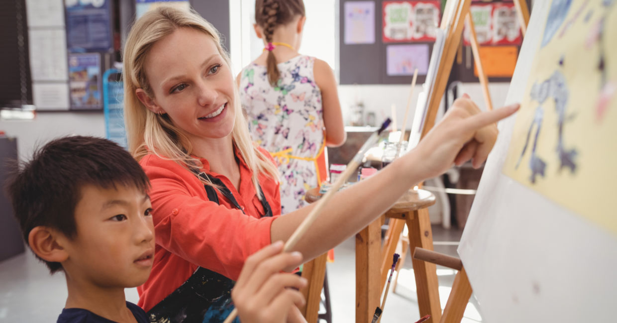 An elementary school art  teacher with a student.