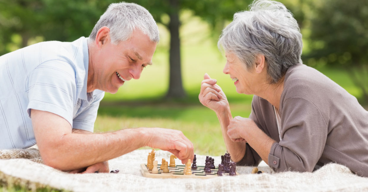 Retired couple playing chess, a brain game.