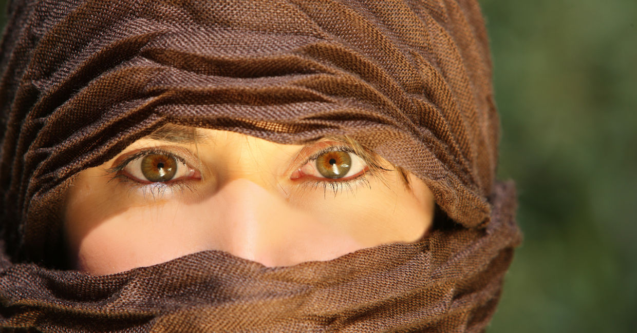 Veiled woman working outdoors