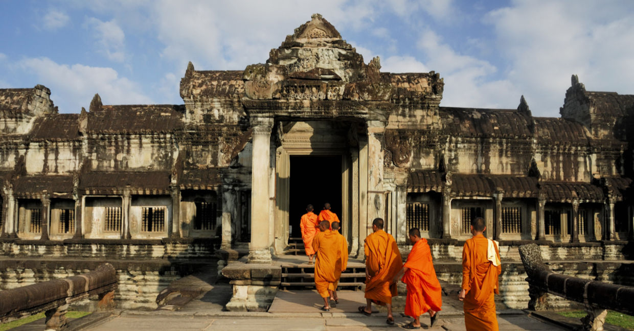 Buddhist monks at Angkor Wat. Ancient Khmer architecture, Ta Prohm temple ruins hidden in jungles. Popular travel destination at Siem Reap, Cambodia
