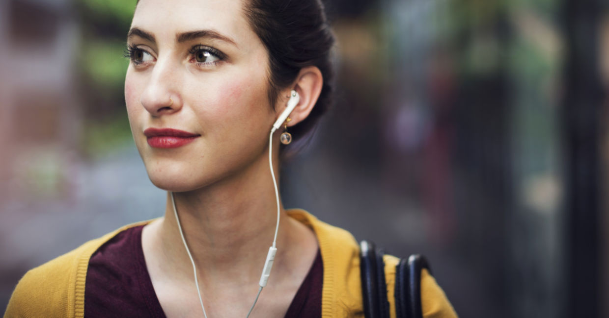 Woman walking and listening to a podcast