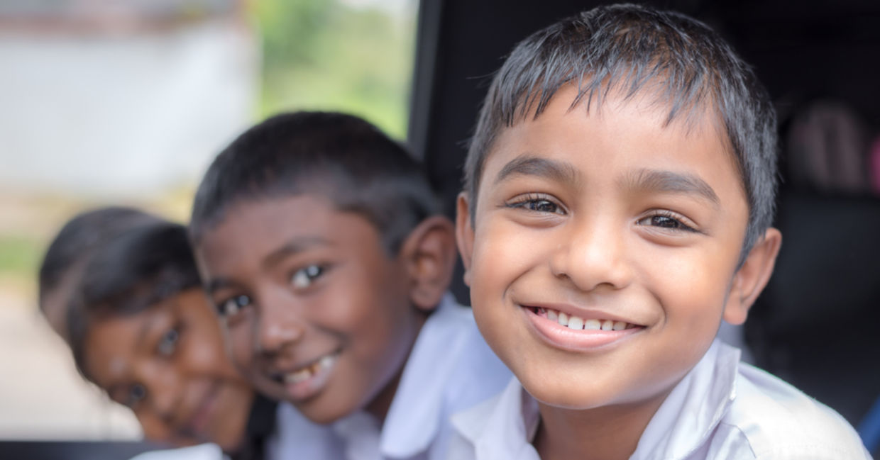 Happy, healthy Indian children smiling as they go to school.